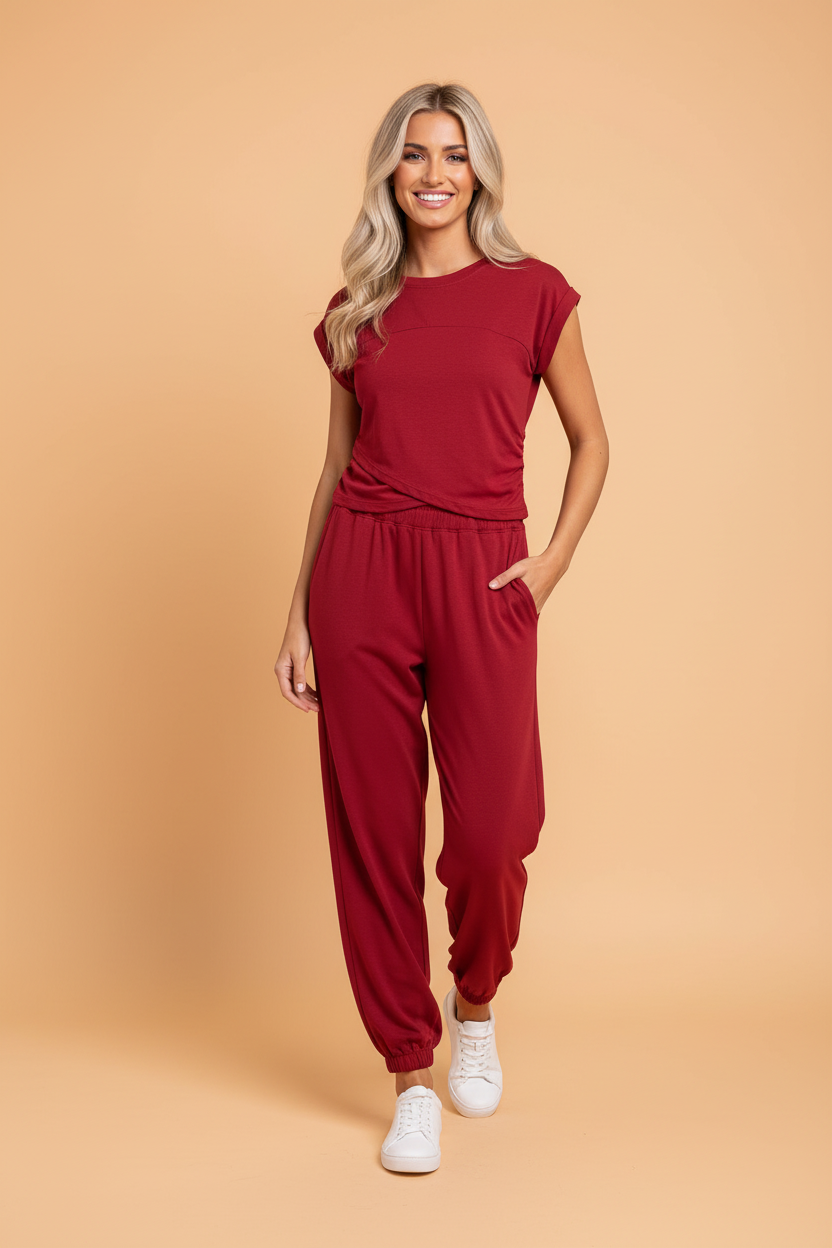 A minimalist solid cropped top with cap sleeves paired with matching jogger pants in a soft knit fabric.