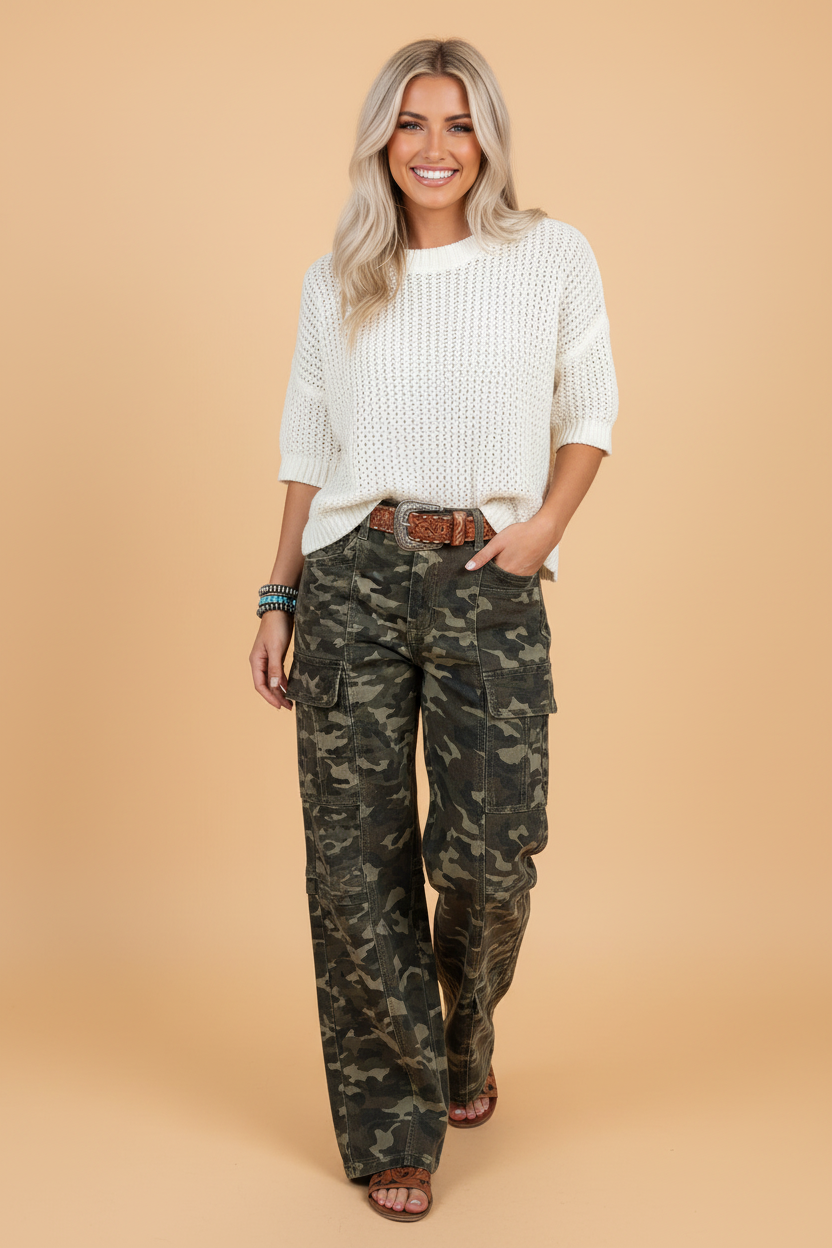 Model wearing high-rise camouflage print denim cargo pants with wide legs and zip-fly closure