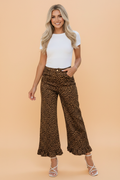 Woman wearing leopard print shift jeans with a ruffle hem and metal button-front closure