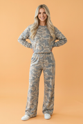 Women wearing a camo long sleeve top and matching loose pants loungewear set in neutral tones