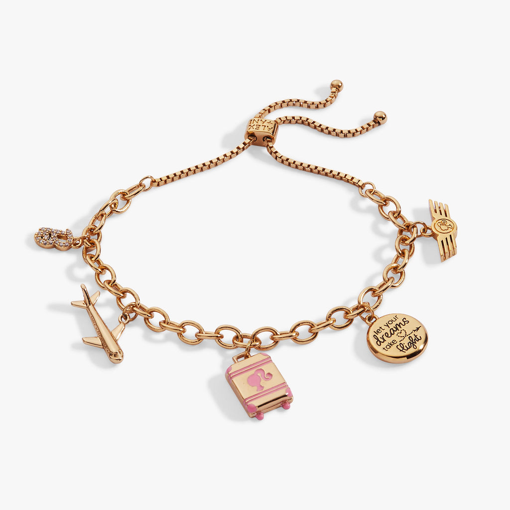 Gold-tone Travel Bolo Bracelet featuring airplane charm and pink enamel suitcase