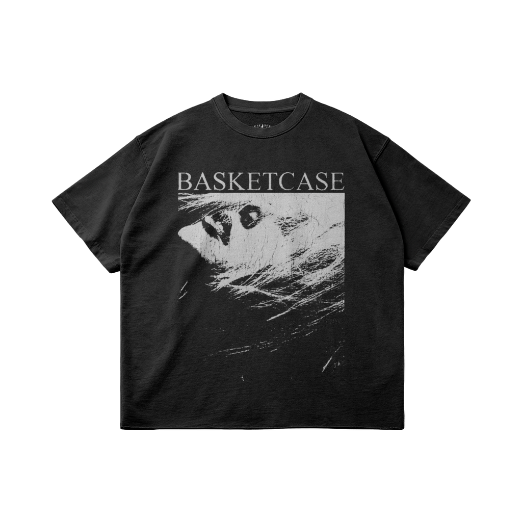 Front and back view of a black garment-dyed T-shirt with a Basketcase graphic print and raw hem detail