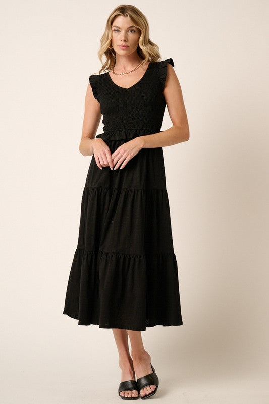 Romantic tiered midi dress with a smocked bodice and ruffled accents.