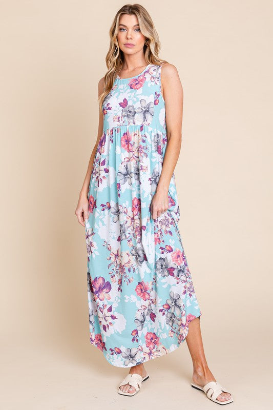 Sleeveless floral print maxi dress with a flowing skirt and side pockets.