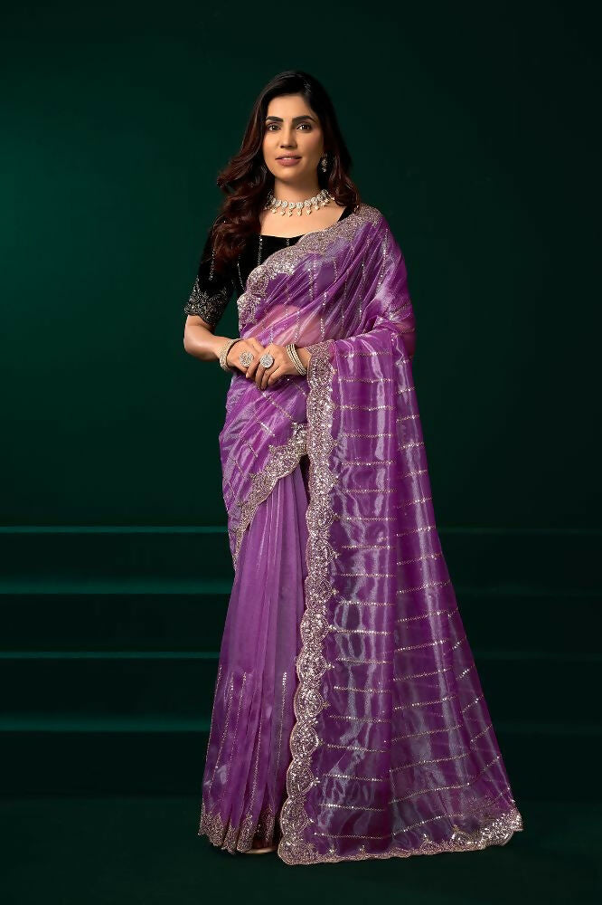 Elegant lavender net saree paired with a contrast black velvet blouse for parties