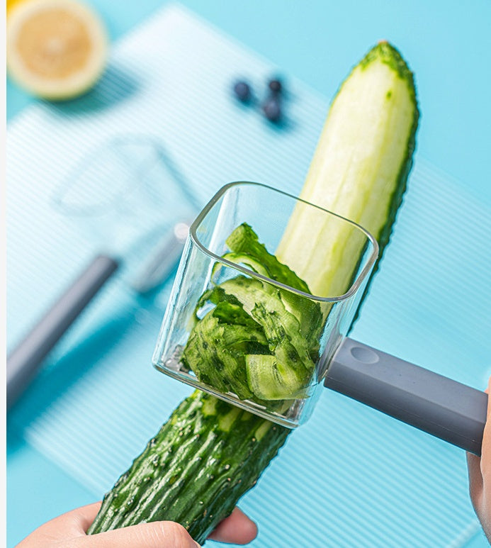 A modern, minimalist stainless steel kitchen peeler available in grey, mint-green, and transparent finishes.