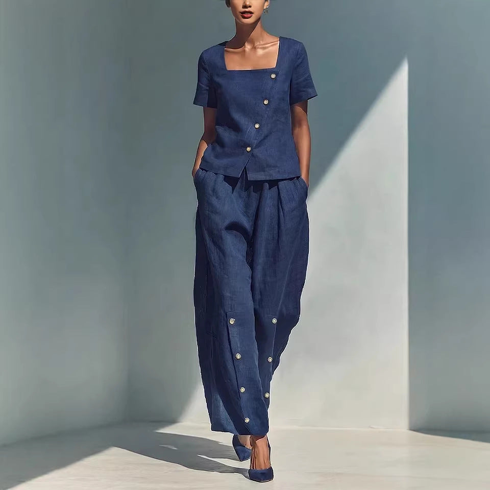 A woman wearing a matching two-piece set with a square neck top and wide-leg pants with button details.
