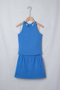 Model wearing a sky blue matching set with a slim tank top and elastic waist mini skort