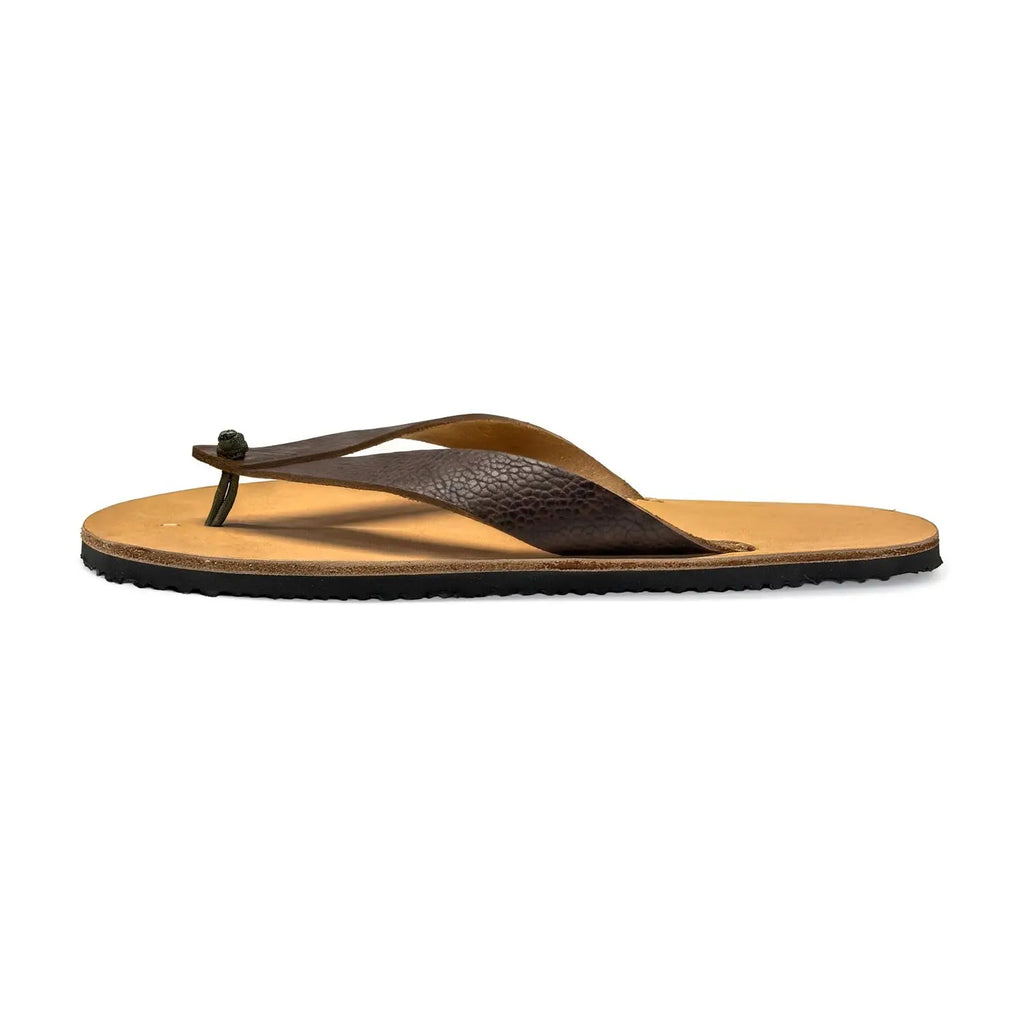 A pair of rugged minimalist Bear-Flops flip-flops in tobacco brown leather with a Vibram outsole.