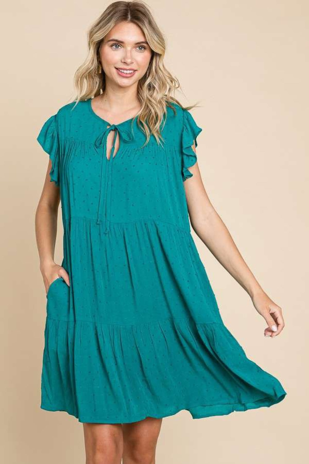Teal green tiered dress with ruffle cap sleeves and a flowy skirt