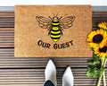 Bee Our Guest themed doormat in brown, black, and yellow