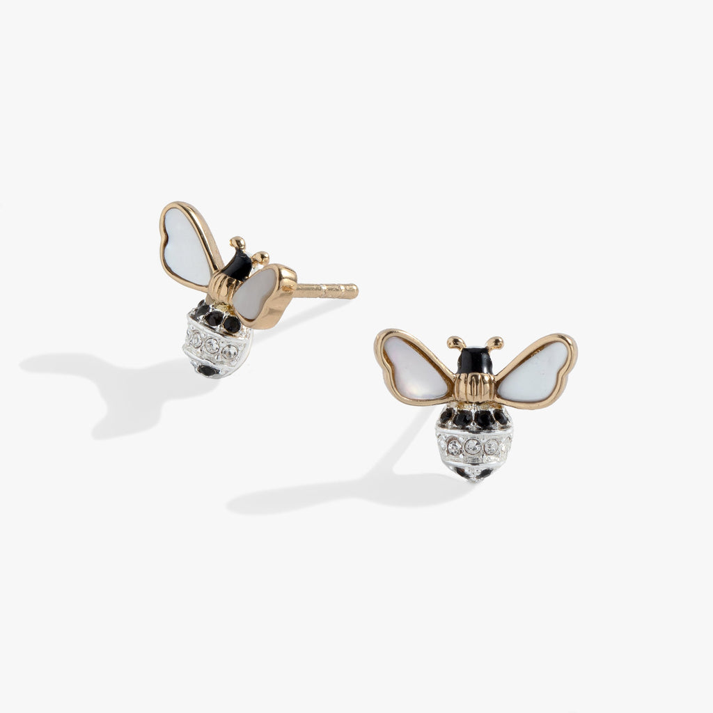 Close up of gold and silver bee stud earrings with iridescent mother-of-pearl wings and crystal details