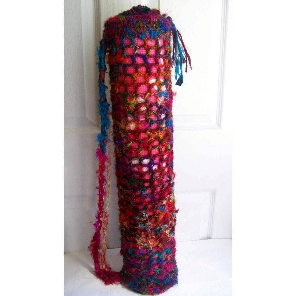Hand-crafted bohemian crochet yoga mat bag featuring vibrant magenta, purple, blue, and gold sari silk yarn with tie closure.