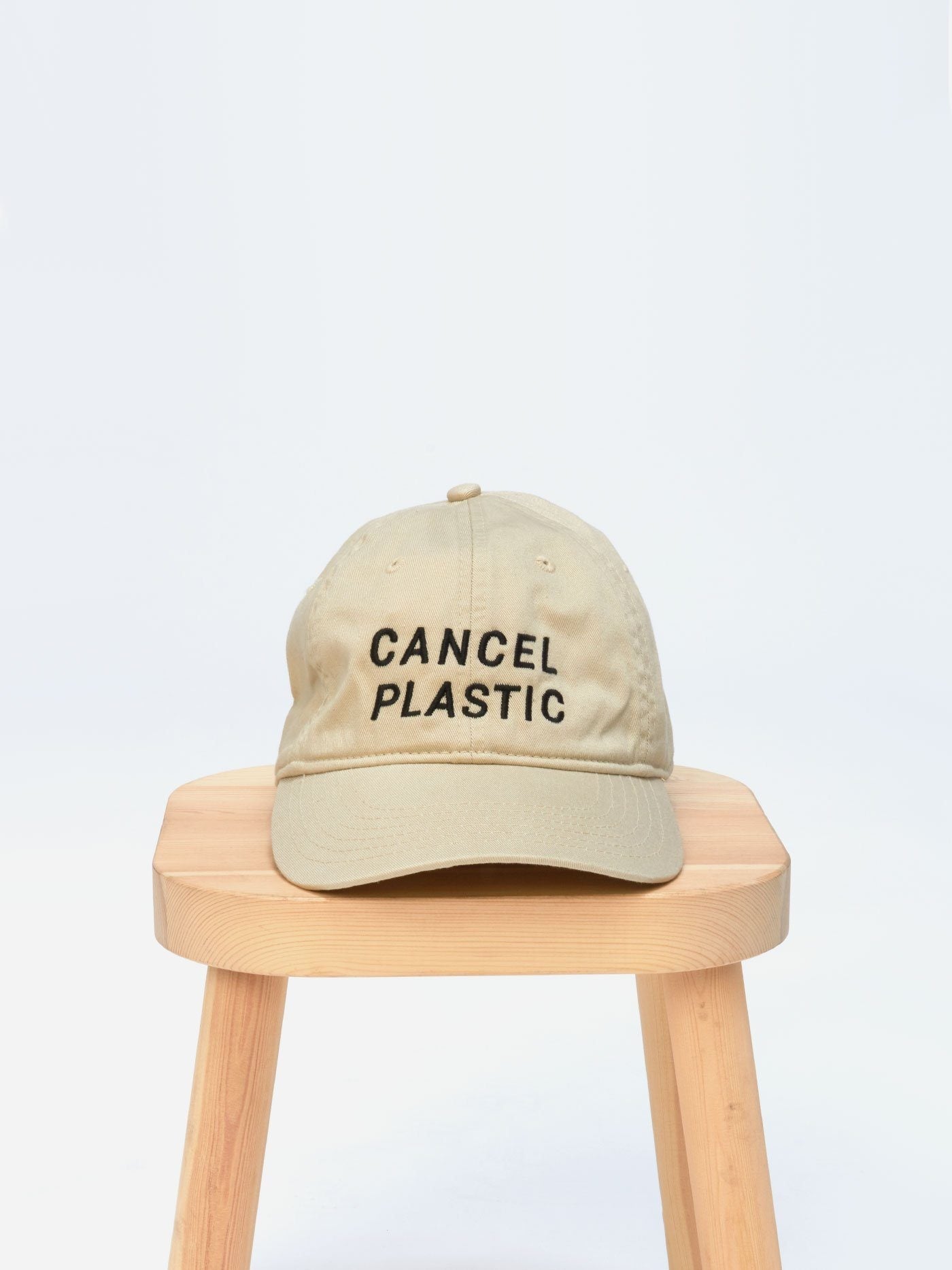 Unisex beige organic cotton hat with Cancel Plastic black embroidery, adjustable back strap
