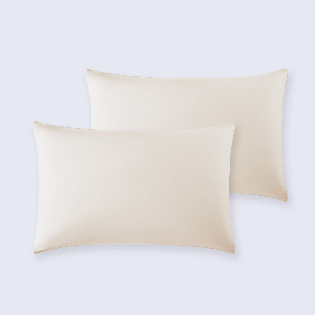 Set of two neutral cooling pillowcases on a bed