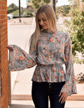 Model wearing the Ava Vintage Blouse in Sage featuring soft rayon fabric and a classic silhouette.