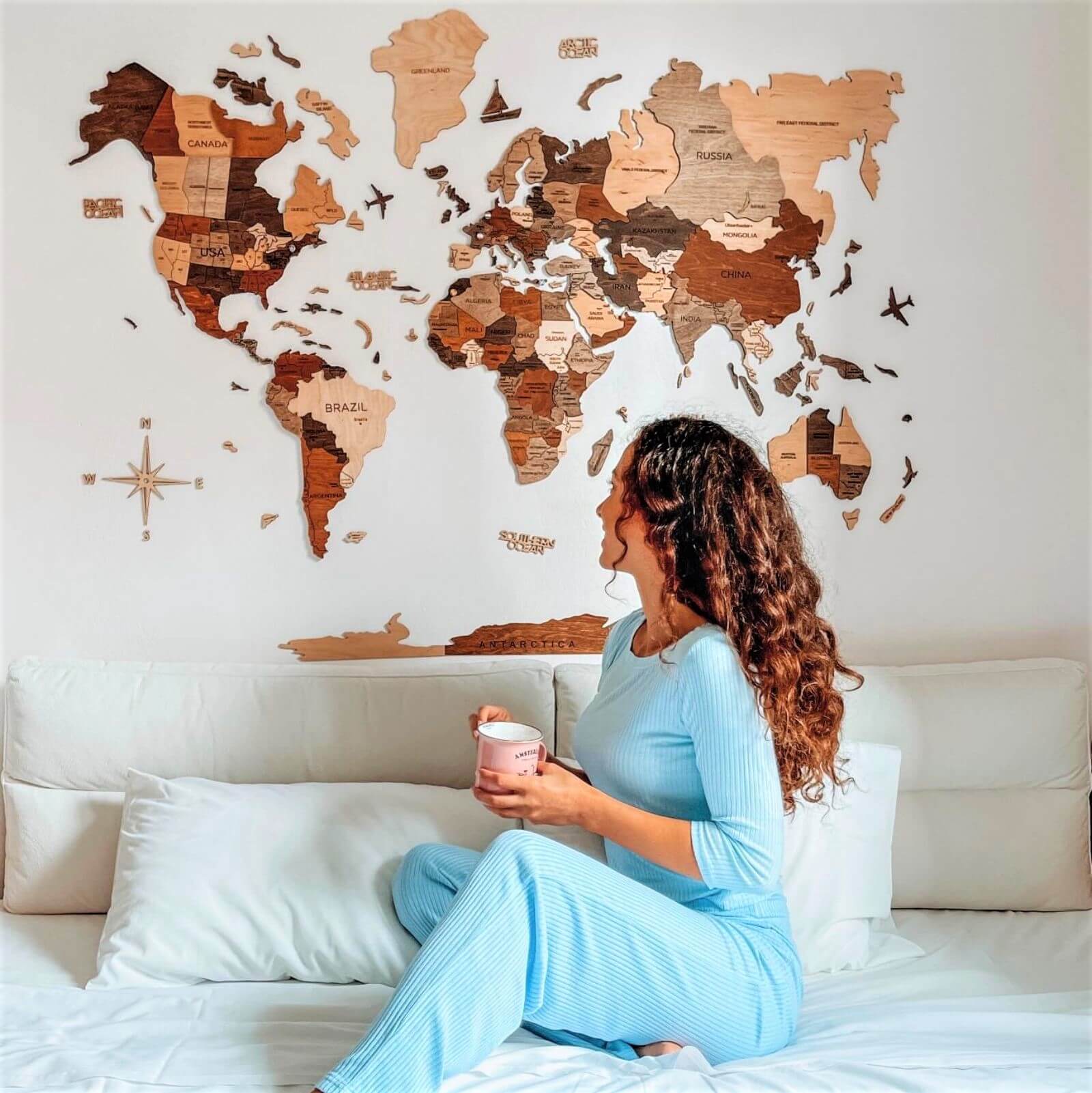 Modern geometric wooden world map in brown, tan, and beige shades on a living room wall