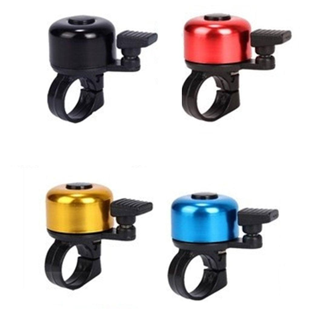 Set of four colorful aluminum bicycle bells for mountain and road bikes on a white background.