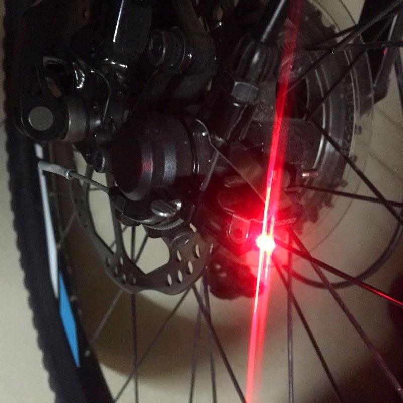 Ultra-bright V-shaped LED bicycle brake light mounted on a bike frame for night safety.