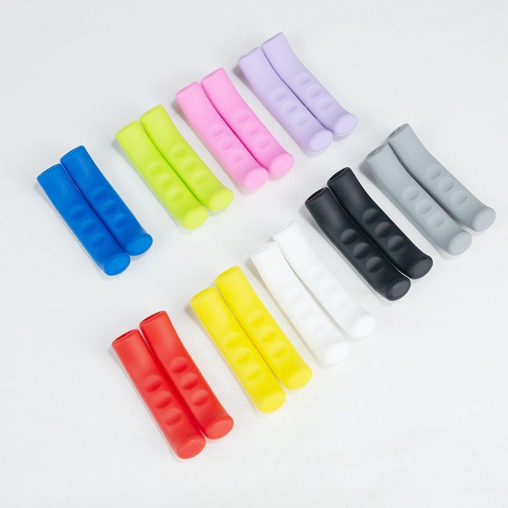 Close up of vibrant silicone bicycle brake handle covers in red, blue, and grey on a modern mountain bike.