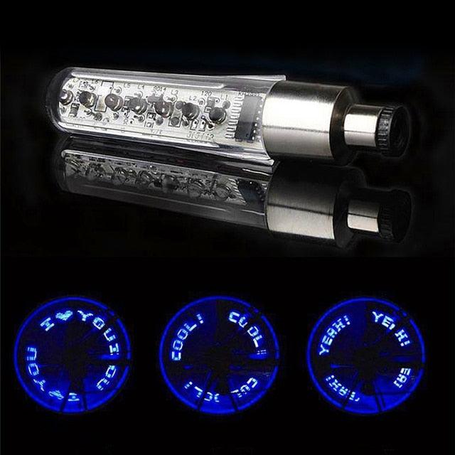 Stevvex LED bicycle wheel light glowing neon on a mountain bike rim at night.