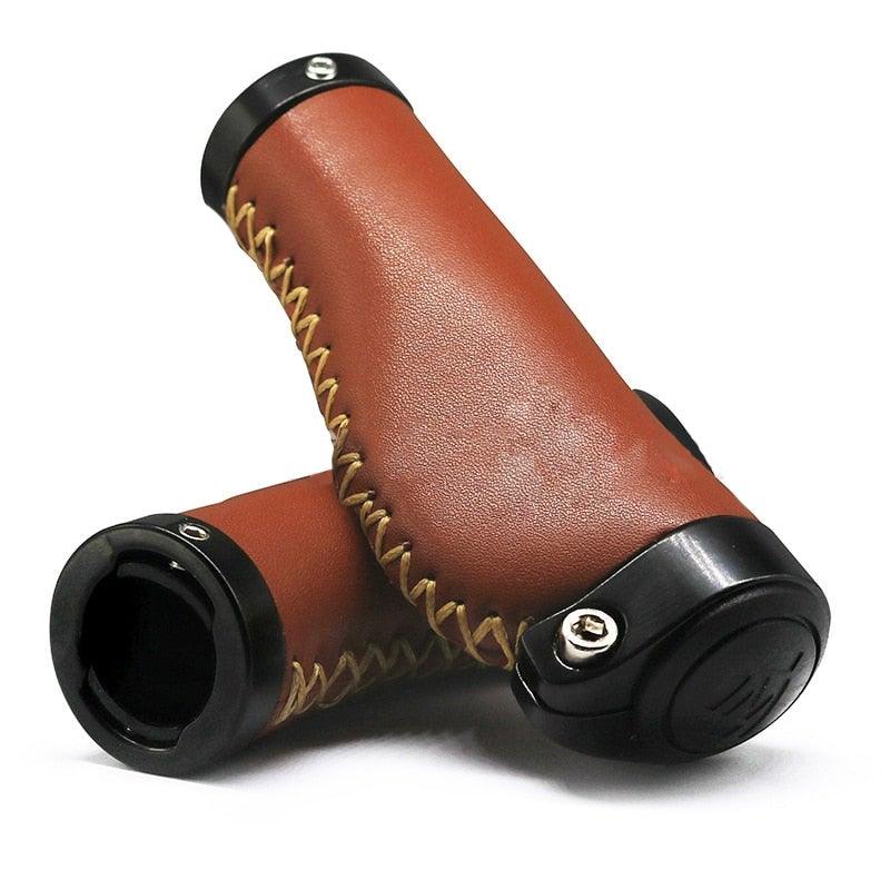Close up of premium brown PU leather bike handlebar grips with aluminum lock-on fasteners.