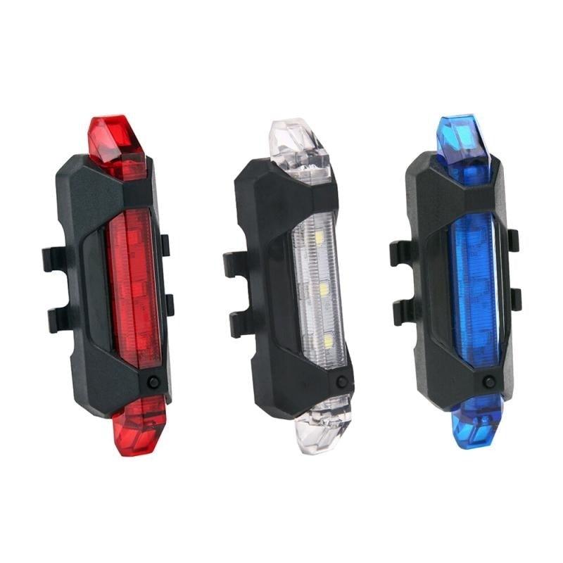Close up of a compact USB rechargeable LED bicycle safety light mounted on a bike frame.