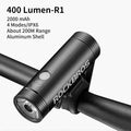 A sleek, matte black industrial-style LED bicycle headlight mounted on a bike frame.
