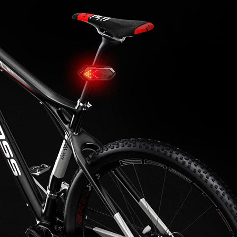 Stevvex LED bike rear light with wireless remote control attached to a bicycle seat post.