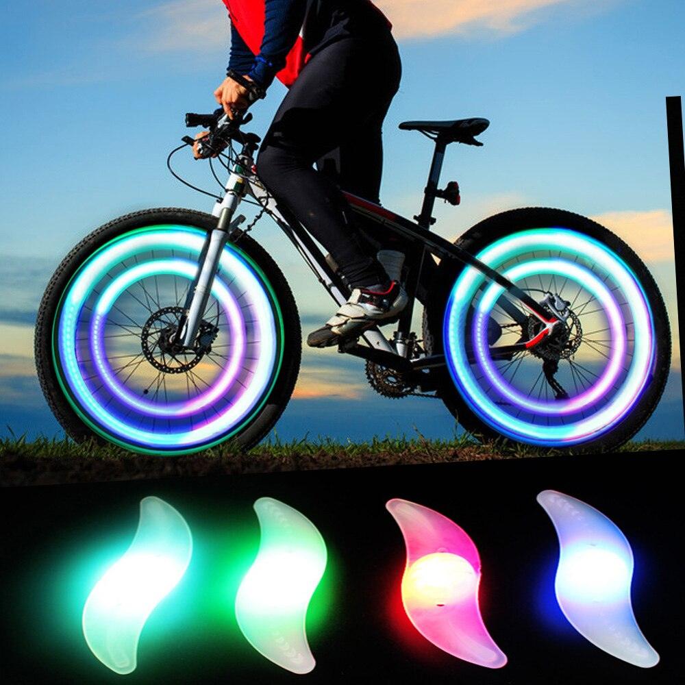 Multicolor LED bike wheel spoke lights attached to a bicycle tire for night riding safety