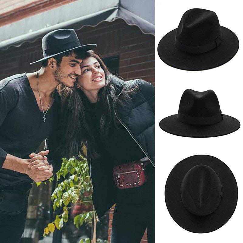 Classic black wide brim fedora hat on a neutral background