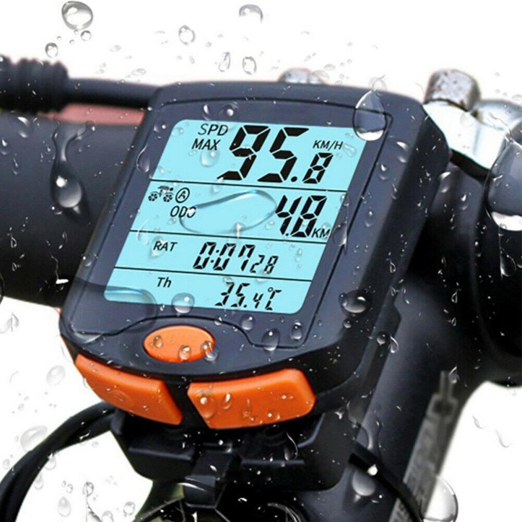 Stevvex digital wired bicycle computer with 4-line backlit display mounted on a bike handlebar.