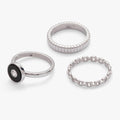 Three-piece ring set featuring a black onyx and clear crystal statement ring with two textured silver stacking bands