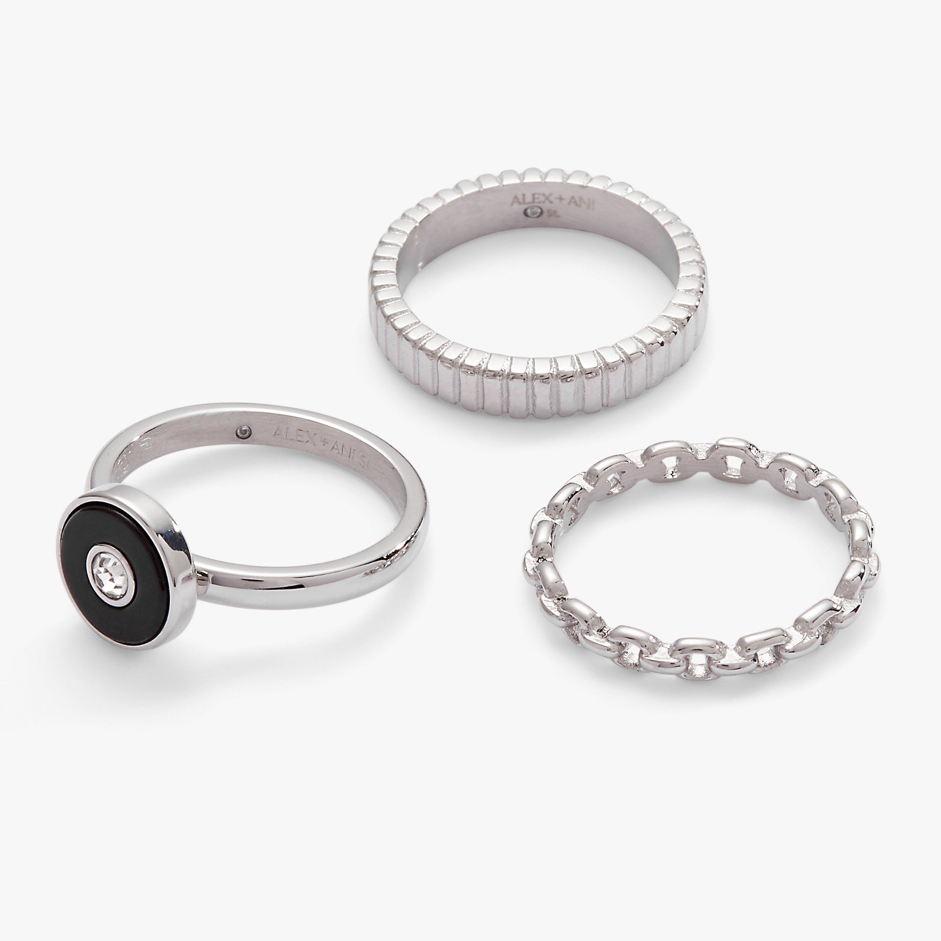 Three-piece ring set featuring a black onyx and clear crystal statement ring with two textured silver stacking bands