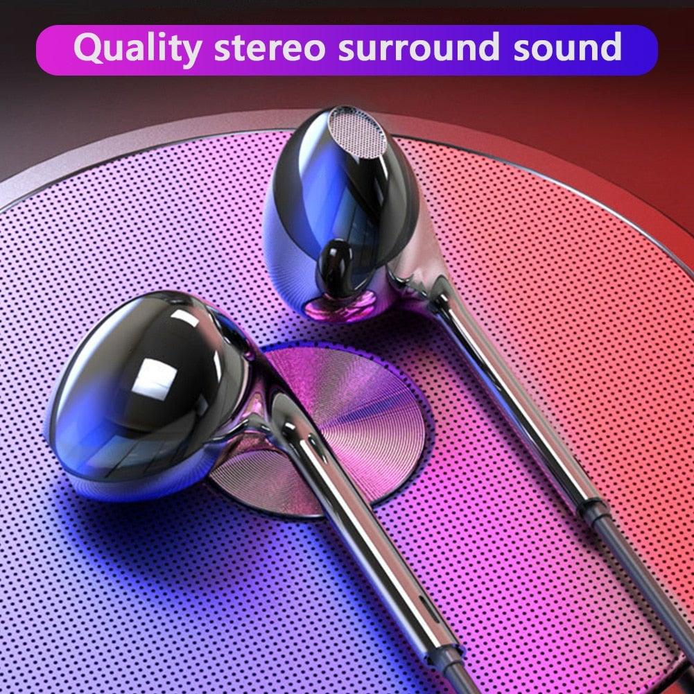 Black and white wired sport earbuds with microphone and volume control inside a portable carrying case.