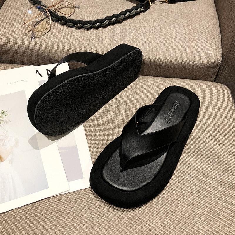 Women's black and white thick bottom platform flip flops with arch support and thong strap design