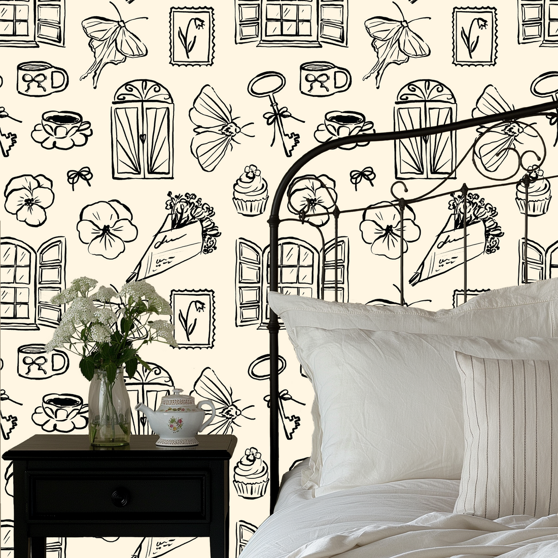 Close up of Lucille vintage illustrative wallpaper in cream and black on a white wall