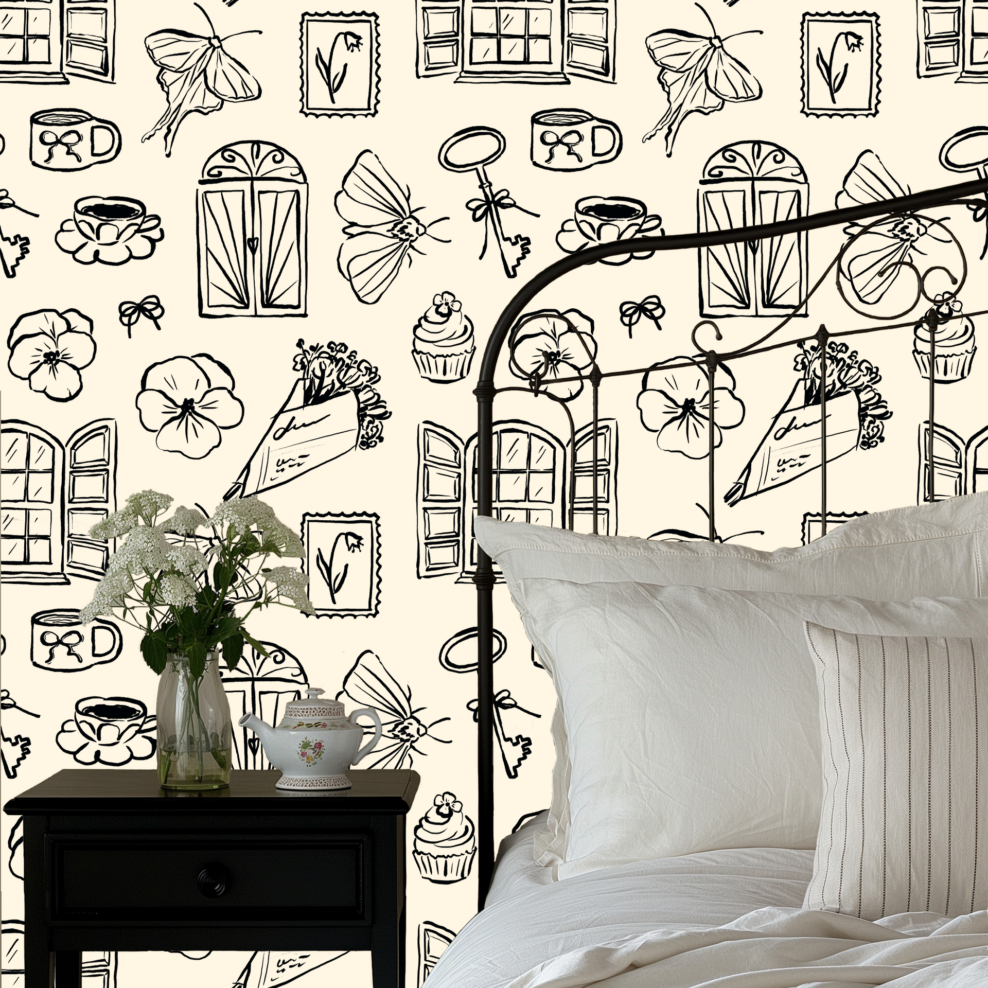 Close up of Lucille vintage illustrative wallpaper in cream and black on a white wall