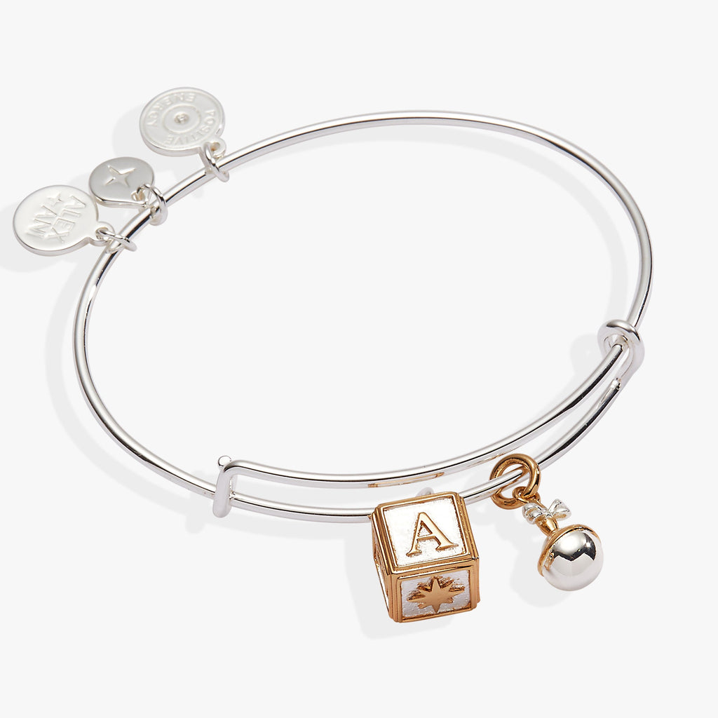 Expandable bangle featuring two-tone silver and gold baby block and rattle charms.