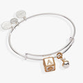 Expandable bangle featuring two-tone silver and gold baby block and rattle charms.