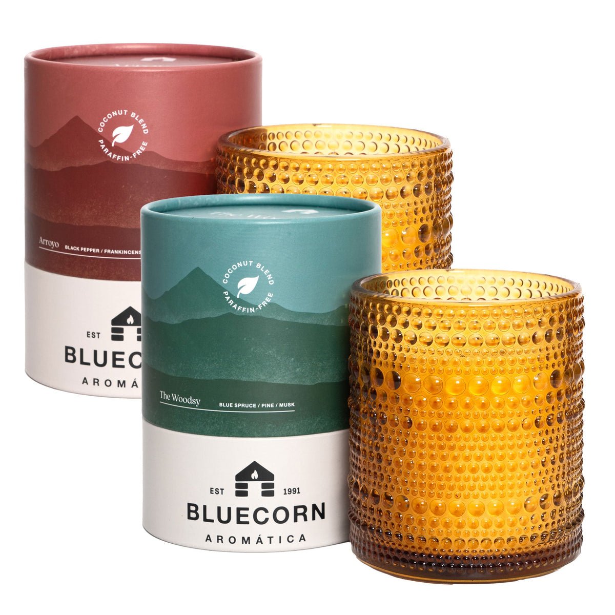 A pair of Pine & Spice Aromática scented candles in festive holiday packaging