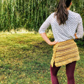 Close up of a handmade crochet wrap skirt featuring intricate bobble stitch detailing.
