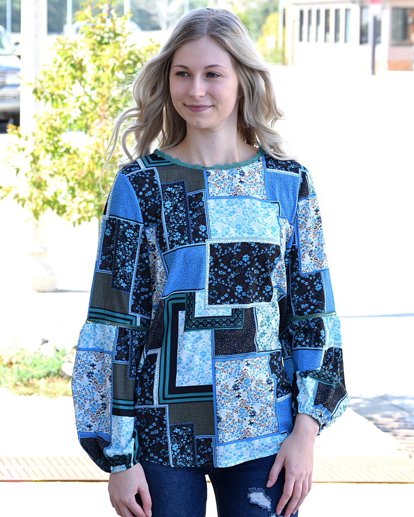 A woman wearing a Bohemian Floral Print Patchwork Top with a comfortable fit.