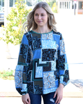 A woman wearing a Bohemian Floral Print Patchwork Top with a comfortable fit.