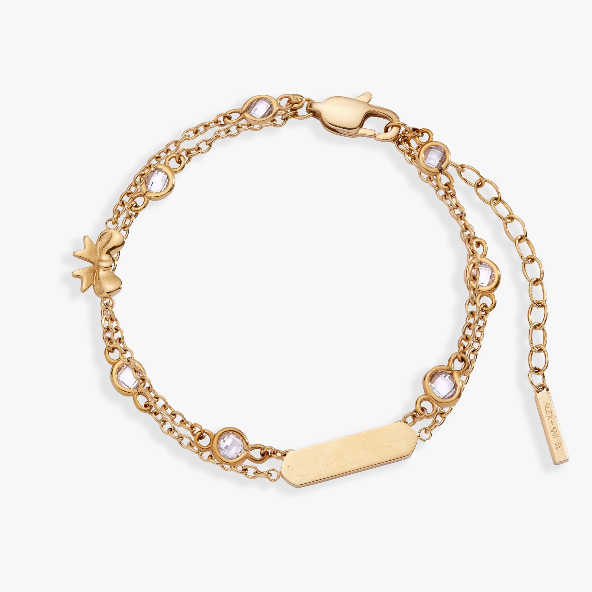 Double strand bracelet with bow symbols and crystal accents in polished metal