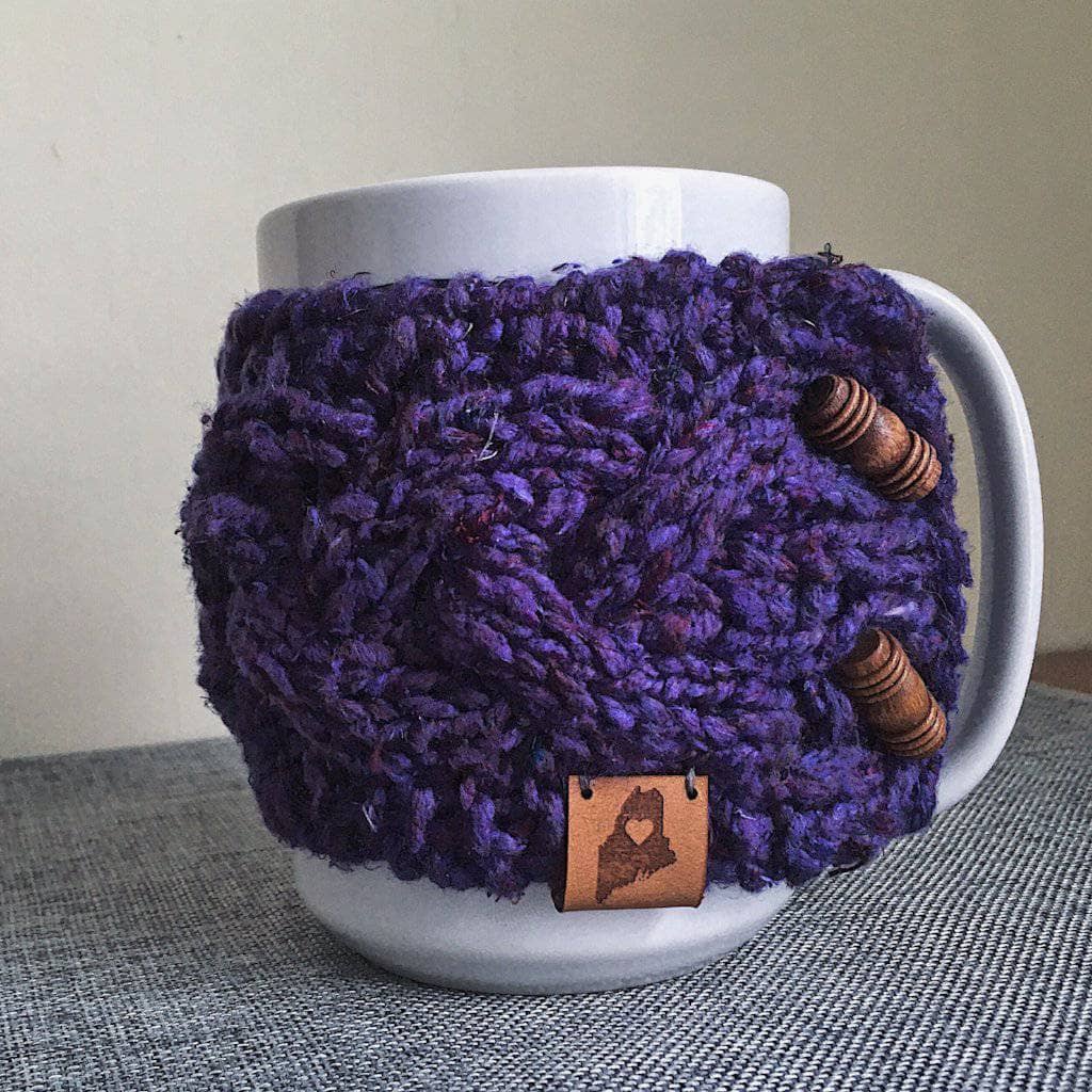 Braided Cable Mug Coozie Knit Kit featuring a cozy, textured knit sleeve on a coffee mug