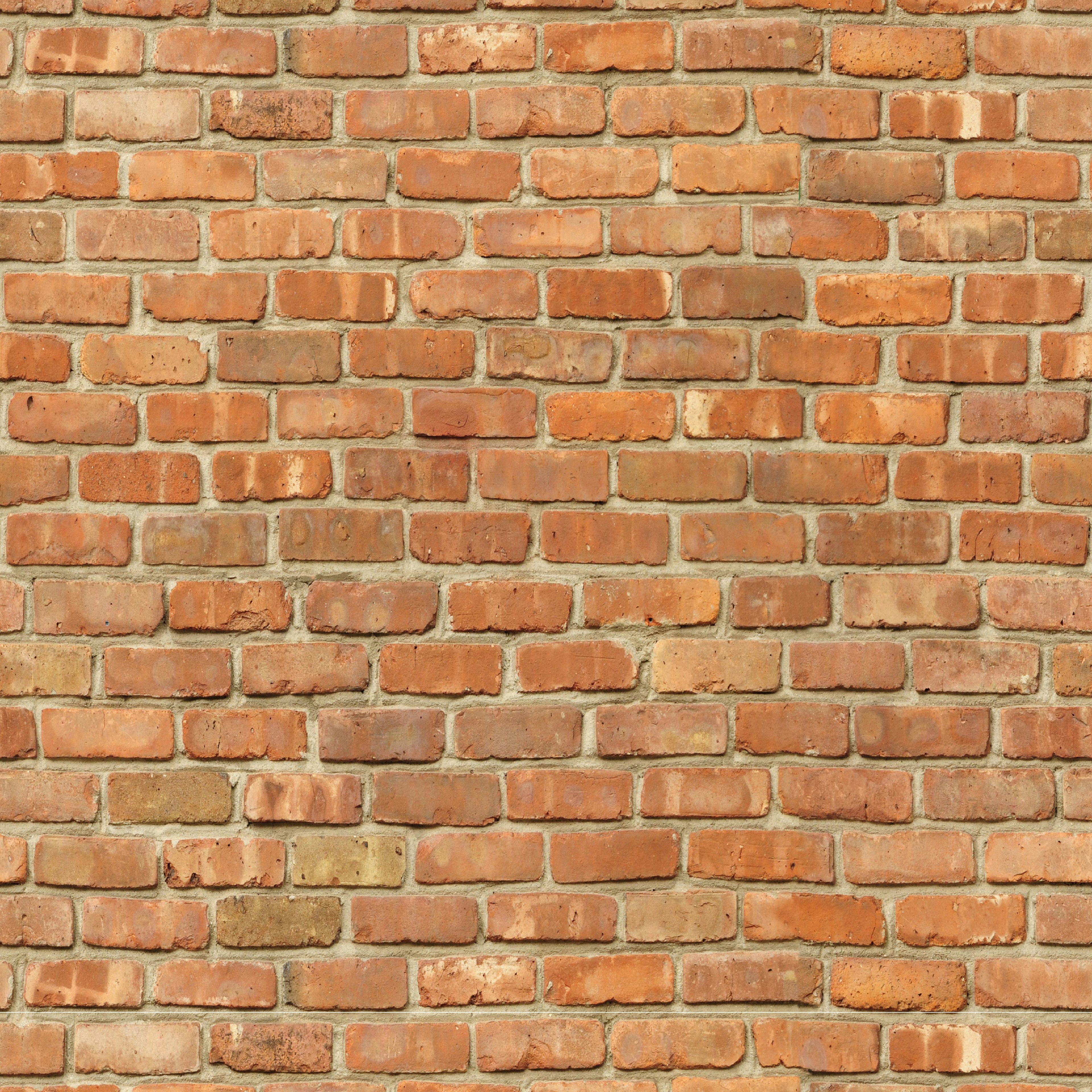 Realistic red and brown brick pattern wallpaper for an industrial or farmhouse aesthetic.