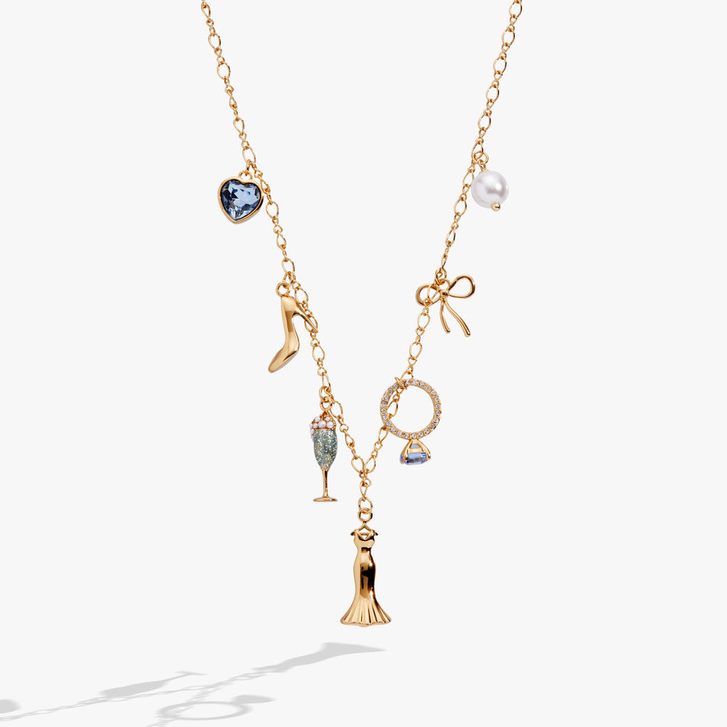 Bridal multi-charm necklace featuring wedding dress, high heel, champagne flute, and blue crystal charms on an adjustable chain.