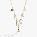 Bridal multi-charm necklace featuring wedding dress, high heel, champagne flute, and blue crystal charms on an adjustable chain.