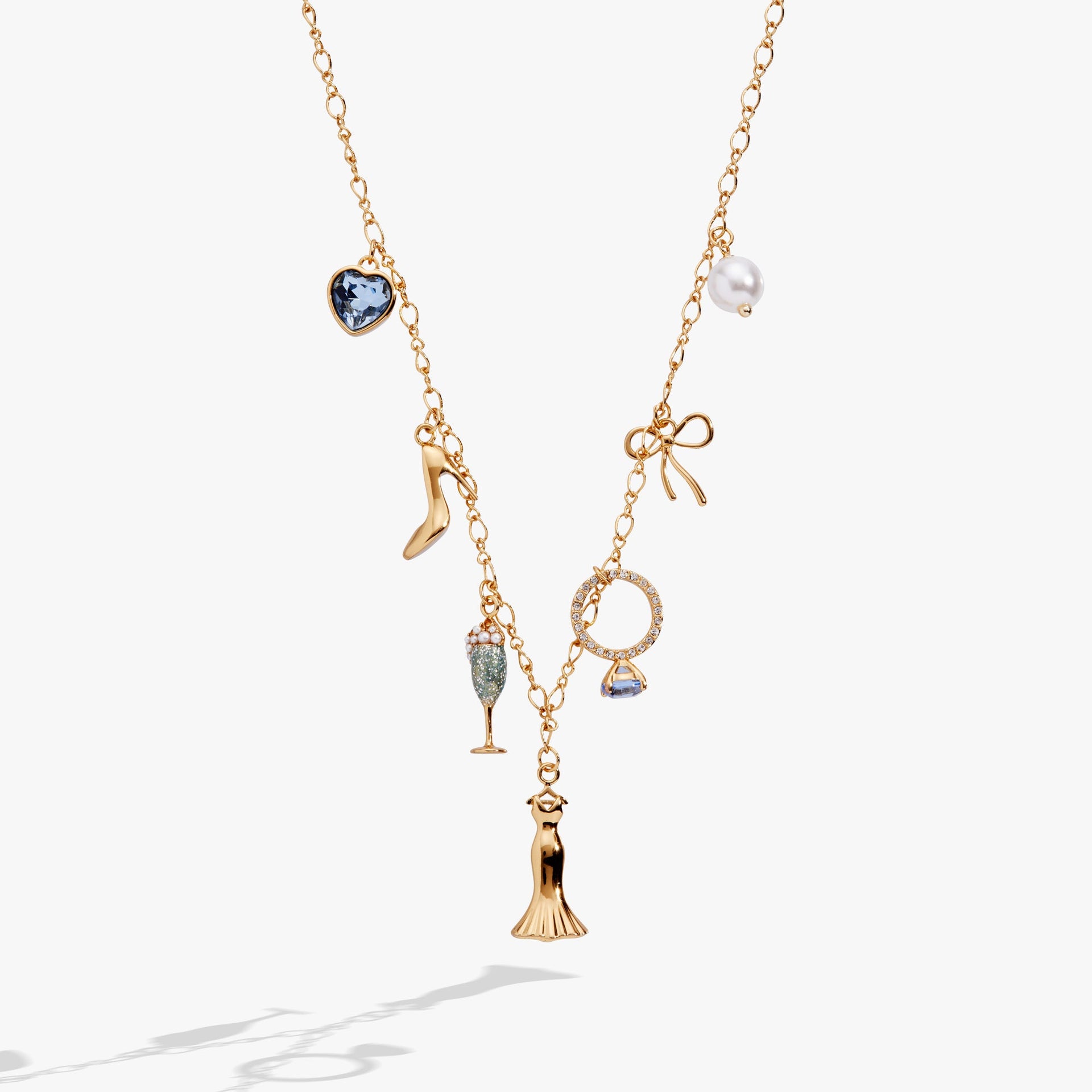 Bridal multi-charm necklace featuring wedding dress, high heel, champagne flute, and blue crystal charms on an adjustable chain.